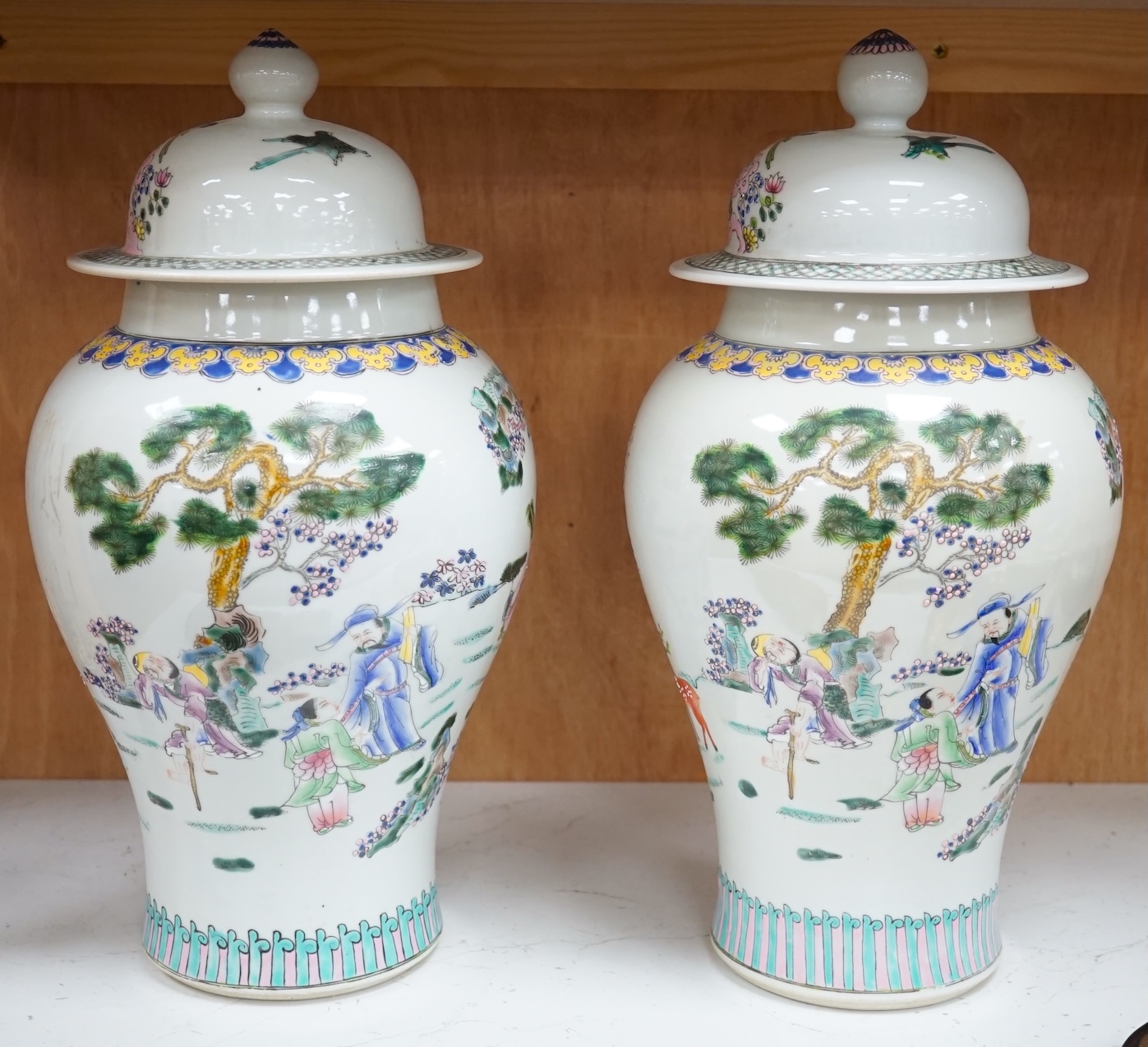 A pair of Chinese famille rose baluster vases and covers, 44cm high. Condition - good